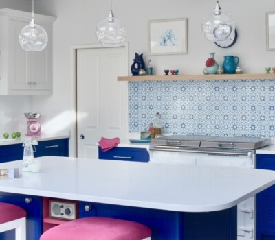 White Everhot in bright blue kitchen with pink stools